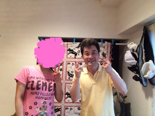 写真加工で顔を隠したピンクのTシャツのかわいらしい女性のお客様と前田歩の笑顔のツーショット写真